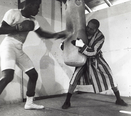 Muhammad Ali training with a boxing bag Photo Print - Item # VARGLP371651