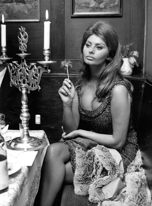 Sophia Loren sitting at a table Photo Print - Item # VARGLP383683