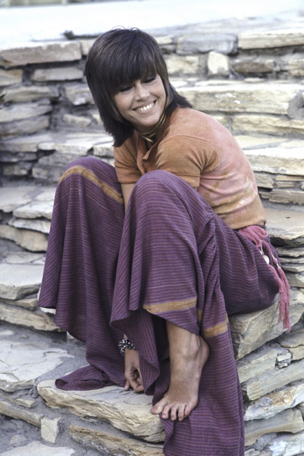 Jane Fonda sitting on a stone wall Photo Print (8 x 10)