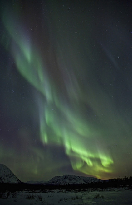 Aurora Borealis Or Northern Lights Above The Mountains Near