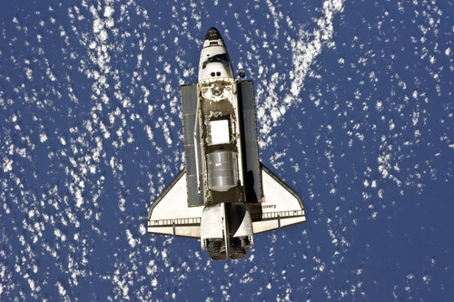 February 26, 2011 - Space shuttle Discovery backdropped by a blue and ...