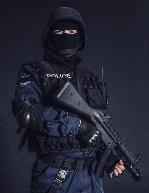 Special weapons and tactics SWAT team officer on black background