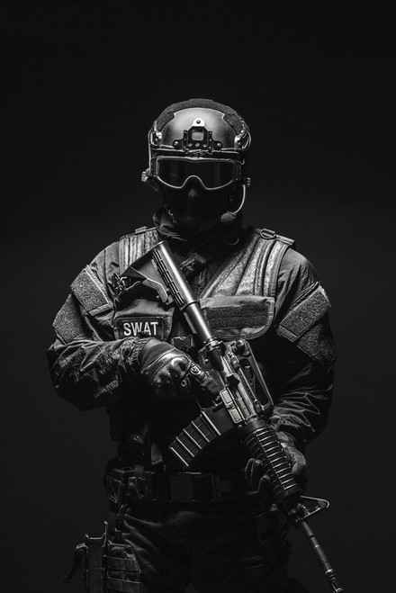 Spec ops police officer SWAT in black uniform and face mask
