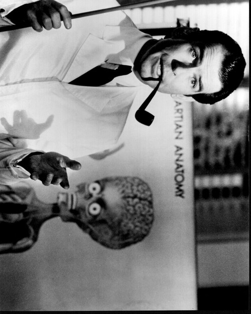 Pierce Brosnan With Pipe In Front Of Alien Anatomy In Mars Attacks