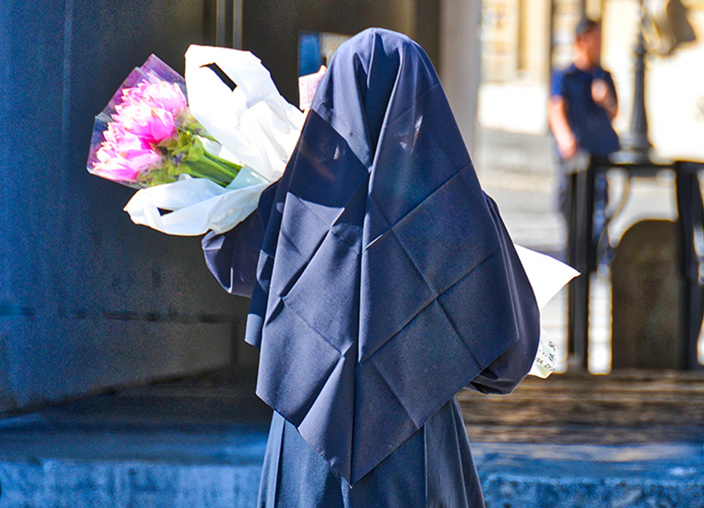 Nun Carrying Flowers