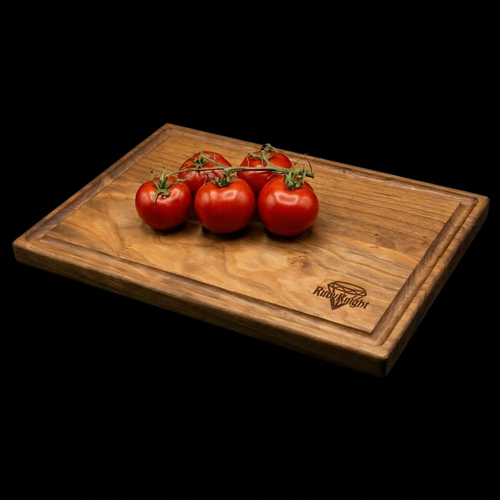 Cherry wood cutting board with Ruby Knight logo engraved on top surface. Shows the juice groove of the cutting board.