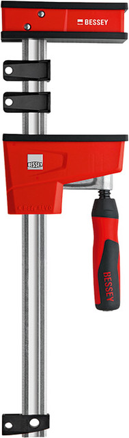 The best parallel clamp in the world just got better! How? By listening to you and building in features that provide the solutions you asked for. The new K BODY REVOlution (KRE) is designed to clamp at 90 degrees to the rail with very large clamping surfaces. The ergonomic two part handle includes a steel socket that allows one to apply clamping force using a hex key. While this helpful feature was designed for ease of clamping, it does allow one to provide more clamping force and is particularly helpful for those with wrist strength issues. The operating jaw has undergone some evolutionary changes as well. Position it where you want and start clamping. The easy set-up allows one to position the operating jaw where you want and, it will stay put during set up. The New BESSEY K BODY REVOlution offers a load limit of 2200 lbs, an everyday clamping force of 1700 lbs and sizes that range from 12 In. to 98 In.   BESSEY. Simply better.