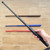High-impact polymer tactical practice baton with textured grip for martial arts training."