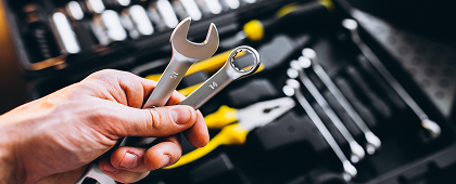 Person holding wrench