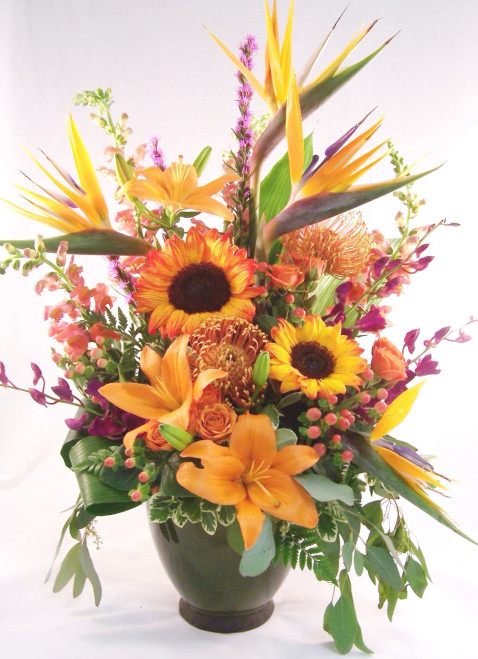 Birds of Paradise, Sun Flowers, Asiatic Lilies, Hypericum Berries, Spray Roses, Protea, Snap Dragons, Dendrobium Orchids, Liatris