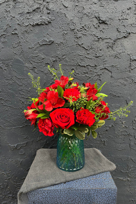 When planning your special day keep in mind this beautiful selection of red roses, alstromeria, and carnations in mind. We'll see you downtown!