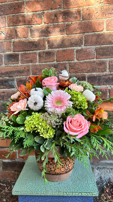 You're a Peach Punkin' blends soft peach blooms with warm autumn textures for a cozy, charming arrangement. With seasonal gourds, rustic greenery, and rich fall tones, it's the perfect centerpiece for gatherings, Thanksgiving tables, or gifting a little autumn sweetness.