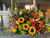 Surround your loved one's urn with a captivating selection of vivid wildflowers, thoughtfully arranged by Main Floral Anoka MN. This striking collection includes sunflowers, lilies, hydrangeas, Bells of Ireland, snapdragons, roses, delphinium, curly willow, stock, and sword fern. Serving the Minneapolis area, these exquisite arrangements are available for same day delivery to both Thurston Deshaw Funeral Home and Thurston Lindberg Funeral Home in Anoka, MN.
