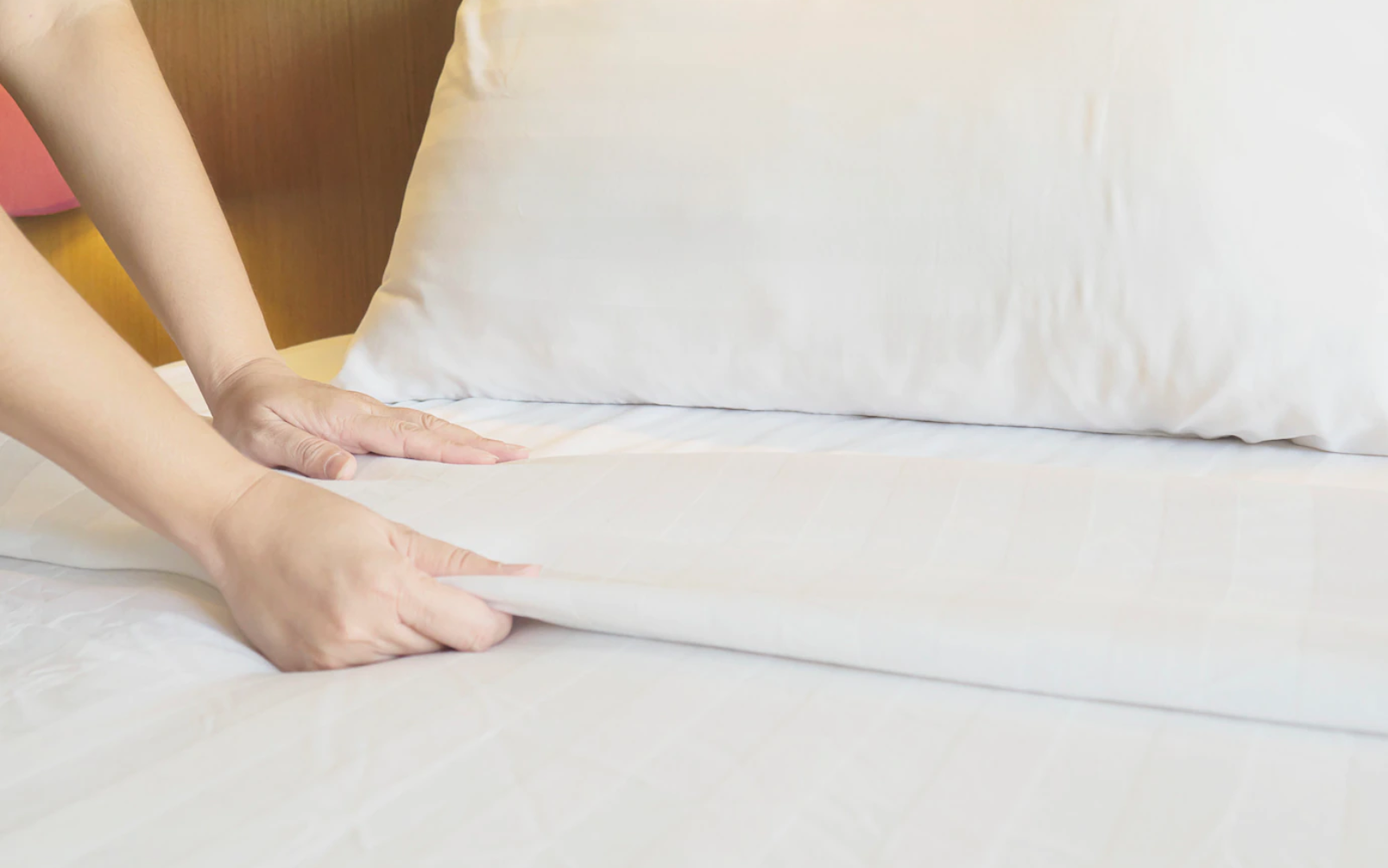 Bed with pillows and hands image