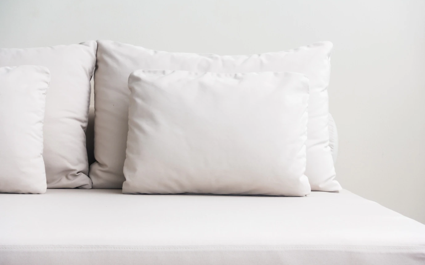 Bed with pillows and hands image