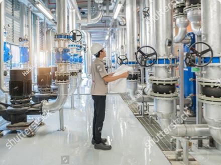 Industrial floor with tanks of chemical materials mounted to chemically resistant sealed concrete floor.