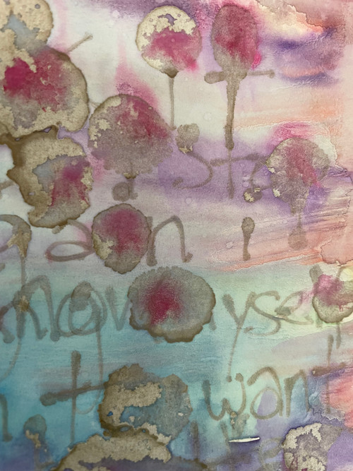 abstract painting with pastels in the background, and words written in gold paint but illegible