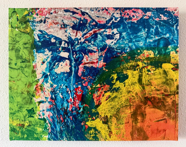 Photo of canvas print from original painting of a sun with orange center and deep yellows around it, on a sky of deep turquoise, with orange, white and red speckles, and bright green on left.