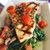 cooked swordfish steak over spinach, mushrooms and cherry tomatoes