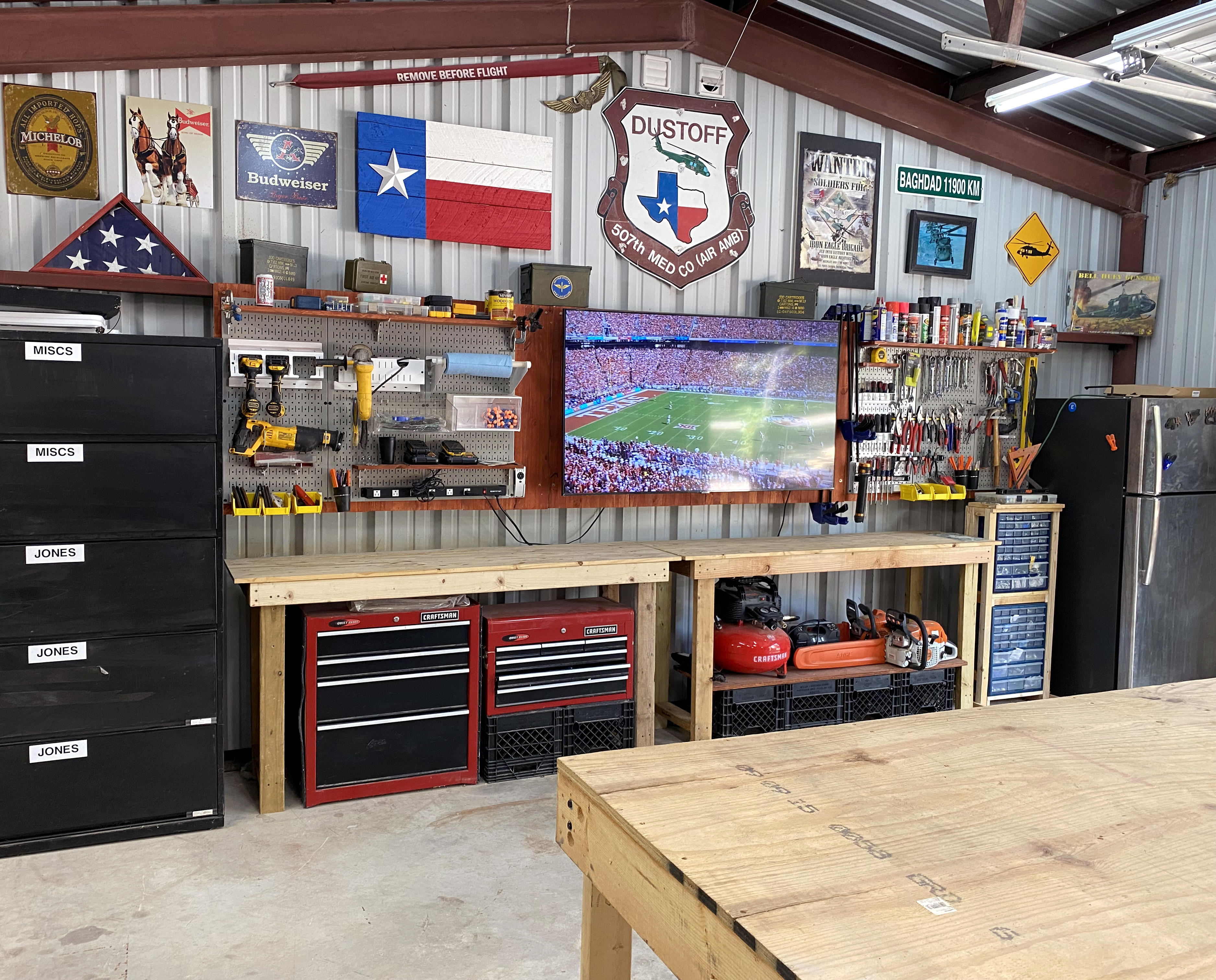 https://cdn11.bigcommerce.com/s-z52bu/product_images/uploaded_images/man-cave-garage-dream-shop-tv-flatscreen-on-metal-pegboard-tool-storage.jpg