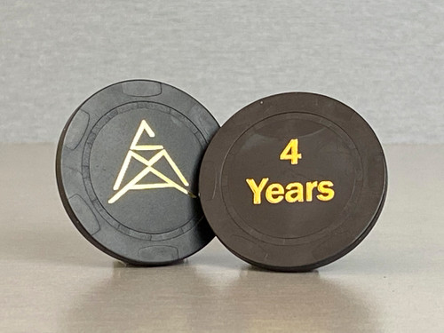 Four year, black anniversary chip with the CMA logo on one side and "4 Years" embossed on the other.