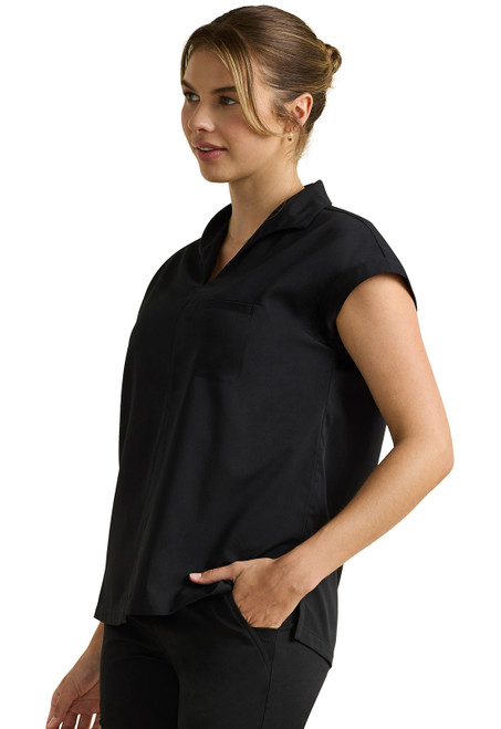 Left View of HH Purple Label Jazz Collared Tuckable Shirt HH607: A stylish scrub with notch collar, dolman sleeves, and chest pocket. Soft, breathable blend ensures comfort. Modern fit with high-low hem, ideal for healthcare professionals.