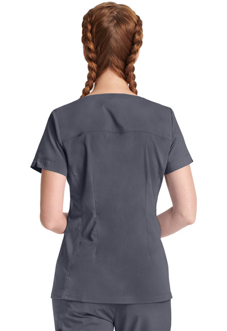 Back view of HH Purple Label Jean Top: essential medical uniform. Made of 77% polyester, 20% rayon, 3% spandex. Features comfort, flexibility, style, 3 pockets, and side vents for mobility.