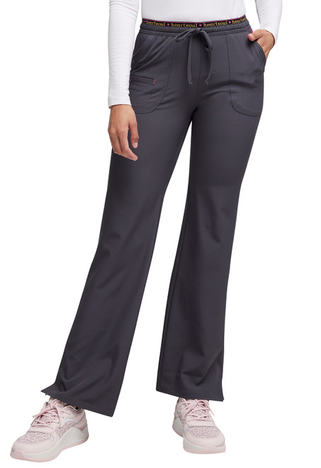 The Break On Through Petite Low Rise Drawstring Pant offers stylish, durable scrubs for healthcare professionals. Features include a low-rise fit, flare leg, adjustable drawstring, and ample pockets, blending comfort with functionality.