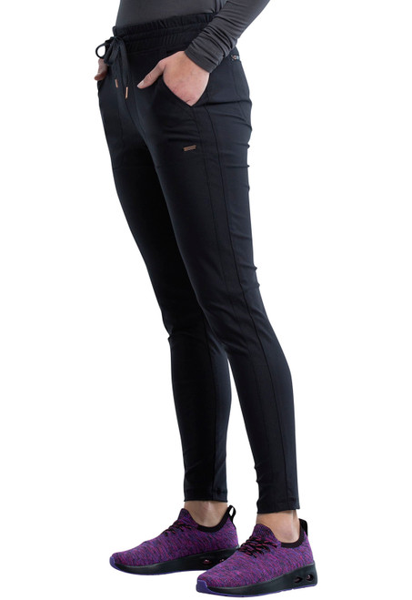 Cherokee Form Tall Mid Rise Tapered Leg Drawstring Pants offer a sleek look in black. Made from durable 86% Nylon / 14% Spandex Knit, these scrubs include multiple pockets for essential storage.