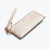 Angled view of Rachel Cruze Slim Wallet in Champagne, front with "rc" embossed