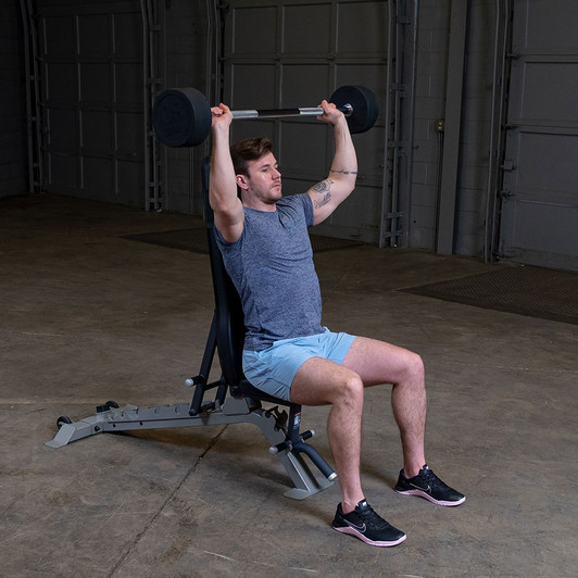 Shoulder Presses with the Body-Solid Tools Fixed Weight Straight Barbells and optional bench