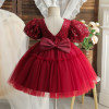Discover enchanting elegance with our girls' red dress. Adorned with beaded sequins on the bodice and featuring a puffy tulle skirt and sleeves, this charming outfit is lined with soft cotton fabric for ultimate comfort. Complete with a delightful bow detail at the back, perfect for any special occasion