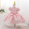 Discover the enchantment of our pink dress for girls - a dreamy creation adorned with glossy satin, puffy sleeves, and delicate pearl trim. Featuring a charming bow in front and back, this dress is beautifully lined with soft cotton fabric for ultimate comfort