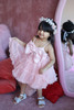 model wearing pink ruffle dress