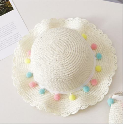 Discover our delightful kids' straw hat and purse set with charming pom-pom details! Each set features an adjustable band for a perfect fit on the hat, ensuring comfort and style all day long. Choose from a variety of adorable colors, including white, beige, brown, and pink. Perfect for sunny days and playtime adventures. Shop now and let your little ones shine with this must-have accessory duo!
