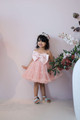 model wearing pink ruffle dress