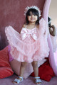 model wearing pink ruffle dress