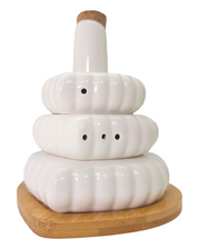White ceramic salt and pepper shakers arranged on a bamboo base with an oil bottle, perfect for bridal shower gifts.