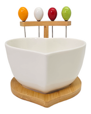 white bowl filled with colorful pics, elegantly displayed on a bamboo stand for a wedding favor or bridal shower white bowl filled with colorful pics, elegantly displayed on a bamboo stand for a wedding favor or bridal shower