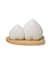 Heart-shaped salt and pepper shakers in white, elegantly displayed on a bamboo stand, ideal for wedding celebrations Heart-shaped salt and pepper shakers in white, elegantly displayed on a bamboo stand, ideal for wedding celebrations