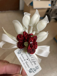 Elegant white flowers tied with red ribbons, ideal for wedding decor and bridal shower celebrations.