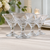 Clear crystal coupe glasses with intricate cut design displayed for wedding favors and special event table settings