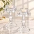 Two elegant clear crystal glass candle holders with faceted detailing and ivory candles, perfect as wedding favors and bridal shower favors or elegant event table decorations.