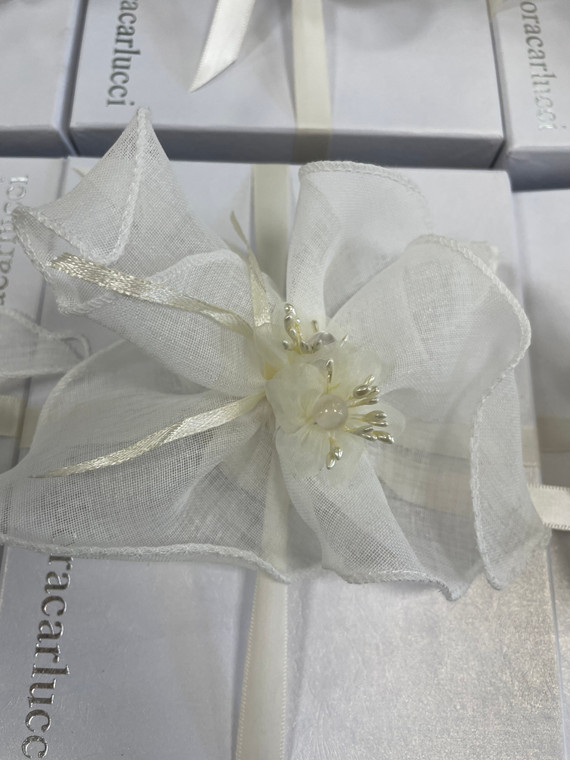 White ribbons and adorned with flowers, perfect for Italian wedding favors.