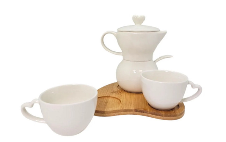 A coffee pot and two cups elegantly arranged on a wooden tray, perfect for cozy gatherings or special occasions.