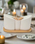 Live image of A three-piece white ceramic condiment set, featuring salt and pepper shakers with a toothpick holder, elegantly displayed on a bamboo tray. Perfect as wedding favors.