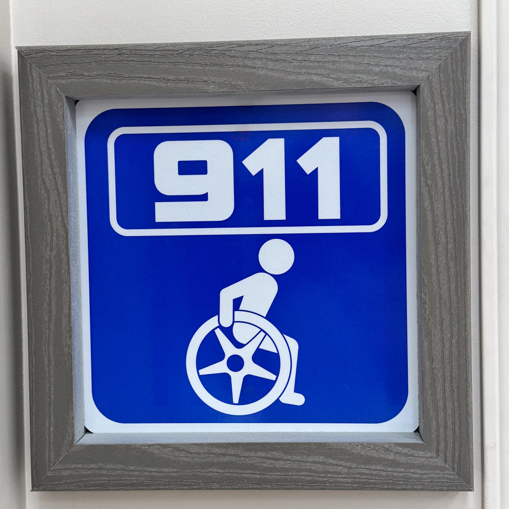 Blue and white EMS 911 wheelchair notification sign with accessibility icon
