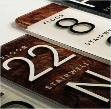 Floor and stairwell identification signs in wood and brushed metal