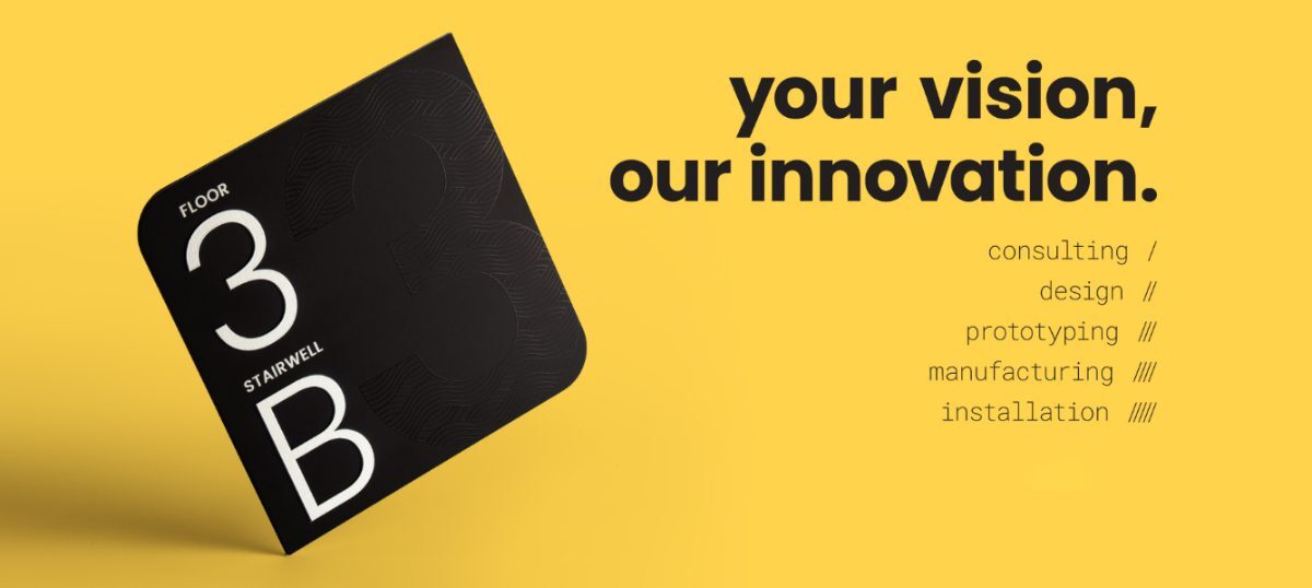 Singularum black floor 3B stairwell sign on a yellow background with the line your vision, our innovation