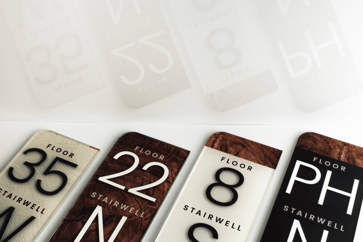 Singularum floor 22 and floor 8 stairwell signs in wood-grain and white finishes